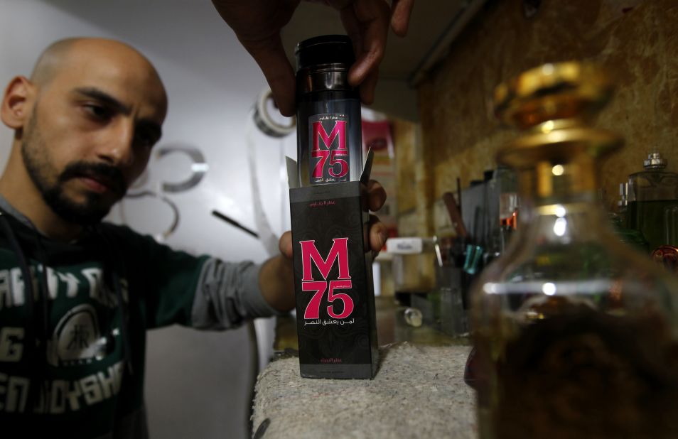 An employee of the 'Stay Stylish' shop in Gaza City displays a bottle of M75 perfume -- named after the long-range rocket used by Hamas in the recent conflict with Israel.