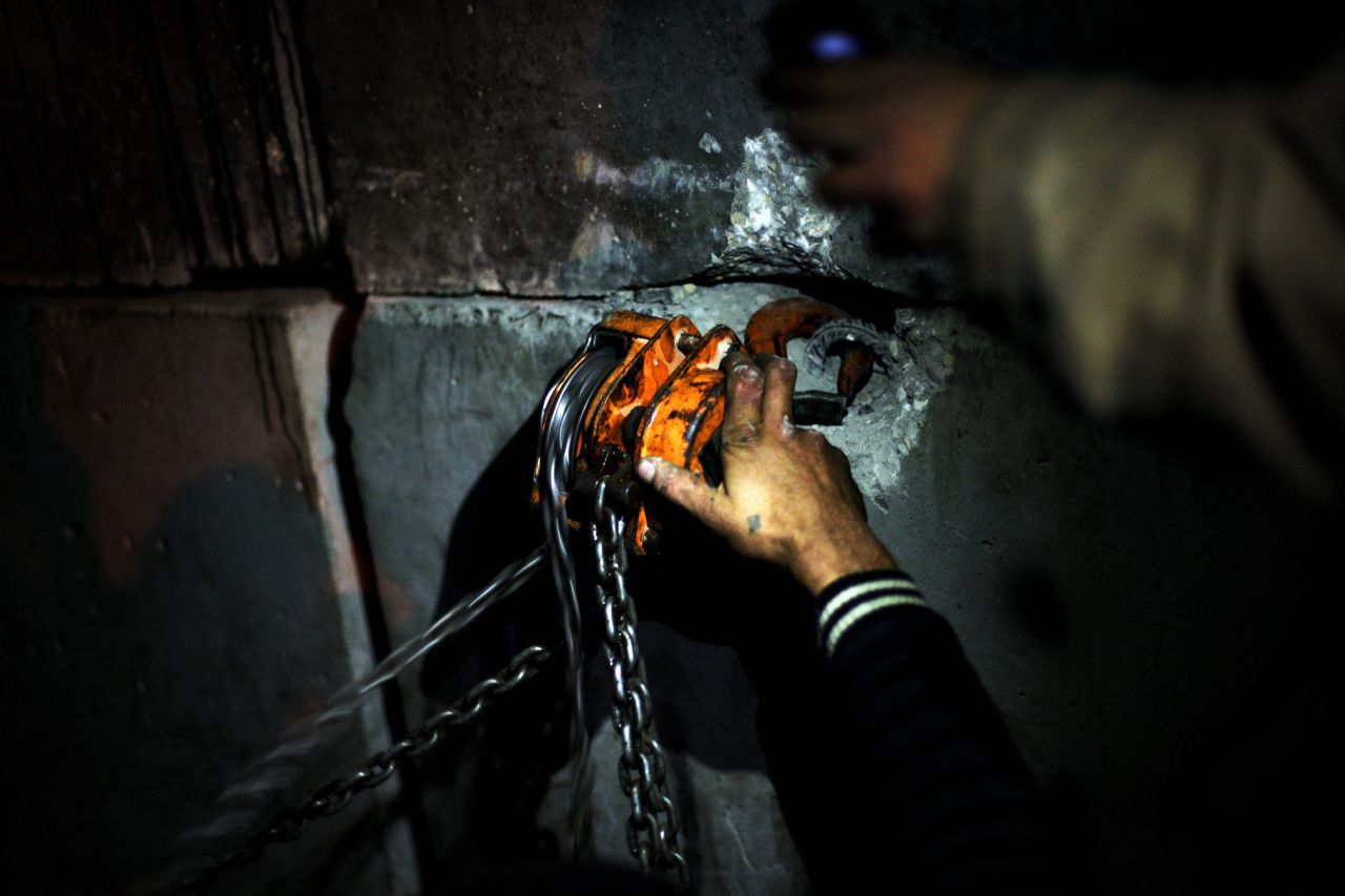 Protesters on December 11 attempt to bring down cement walls that security forces placed around the presidential palace in Cairo.