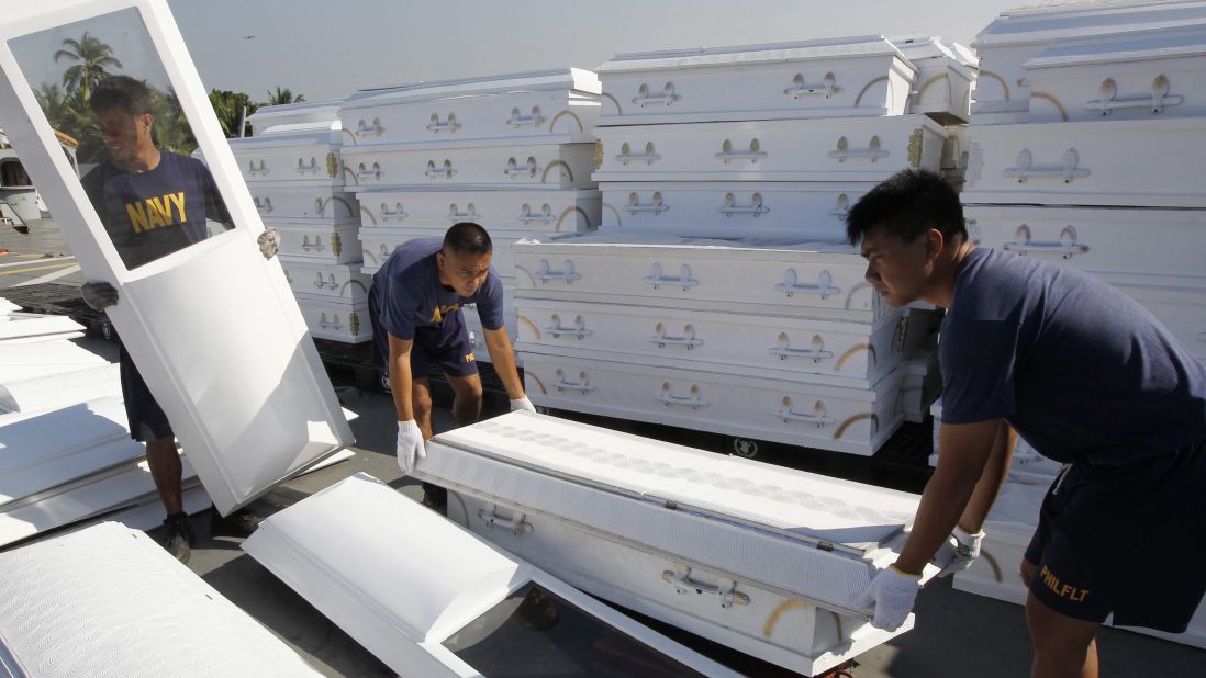 Philippine navy personnel arrange donated coffins aboard the BRP Laguna, which is set to transport relief supplies from a base in Cavite City, on Tuesday, December 11, in the aftermath of Typhoon Bopha. 