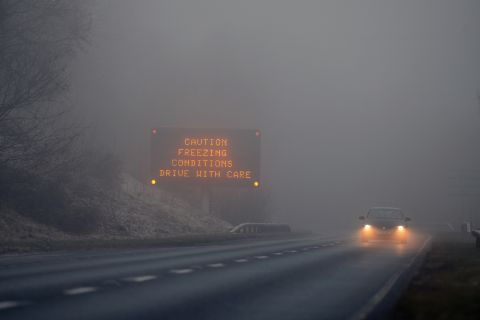 A car drives on the A82 past a road traffic sign on December 12 in Loch Lomond, Scotland.