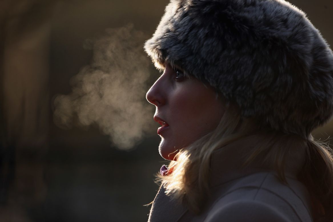 A woman's breath shows on a freezing morning in Regents Park on December 12 in London, England.