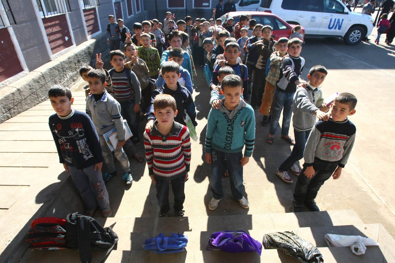 Syrian refugee children wait to enter their class on November 27, 2012 in the Oncupinar camp in Kilis, southern Turkey. 