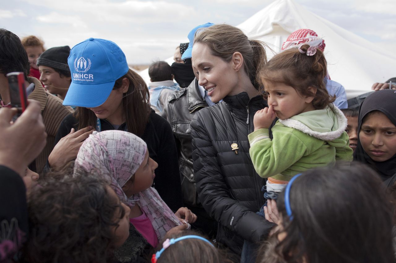 In this handout image provided by UNHCR, UNHCR Special Envoy Angelina Jolie meets with refugees at the Zaatari refugee camp on December 6, 2012 outside of Mafraq, Jordan.