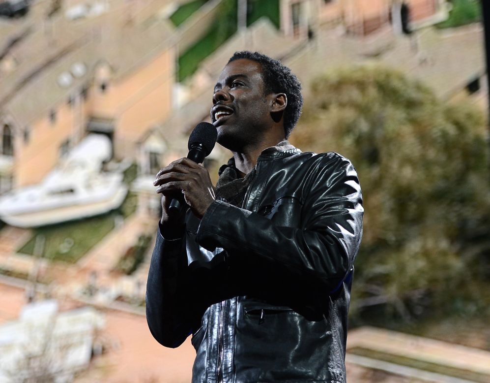 Chris Rock addressed the crowd at Madison Square Garden in front of projected images of Sandy's devastation.