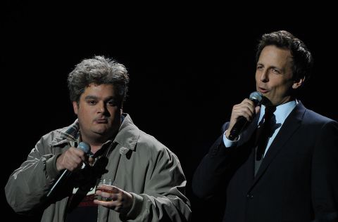 On December 12, 2012, Bobby Moynihan, left, and Meyers perform onstage at New York's Madison Square Garden at the '12-12-12' concert benefiting The Robin Hood Relief Fund to aid the victims of Superstorm Sandy.