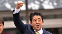 Japan's main opposition Liberal Democratic Party (LDP) leader Shinzo Abe (R) raises his fist alongside an LDP member (L) in support of his party's candidate Yoshitami Kameyama at Fukushima, northern Japan on December 4, 2012.