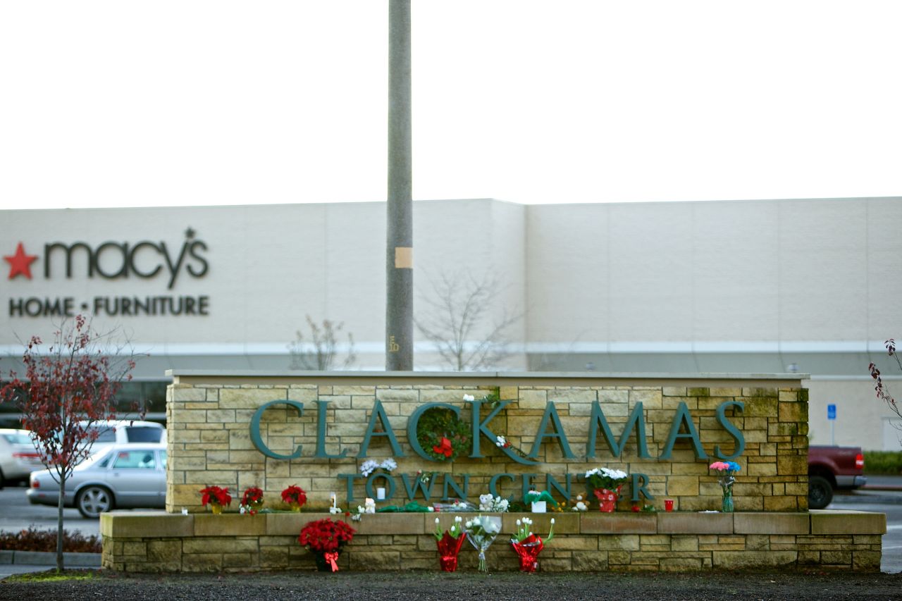 A makeshift memorial graces the Clackamas mall sign on December 13.