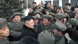Well-wishers mob a smiling North Korean leader Kim Jong Un (without hat) on Wednesday after the successful launch of the country's first satellite. 