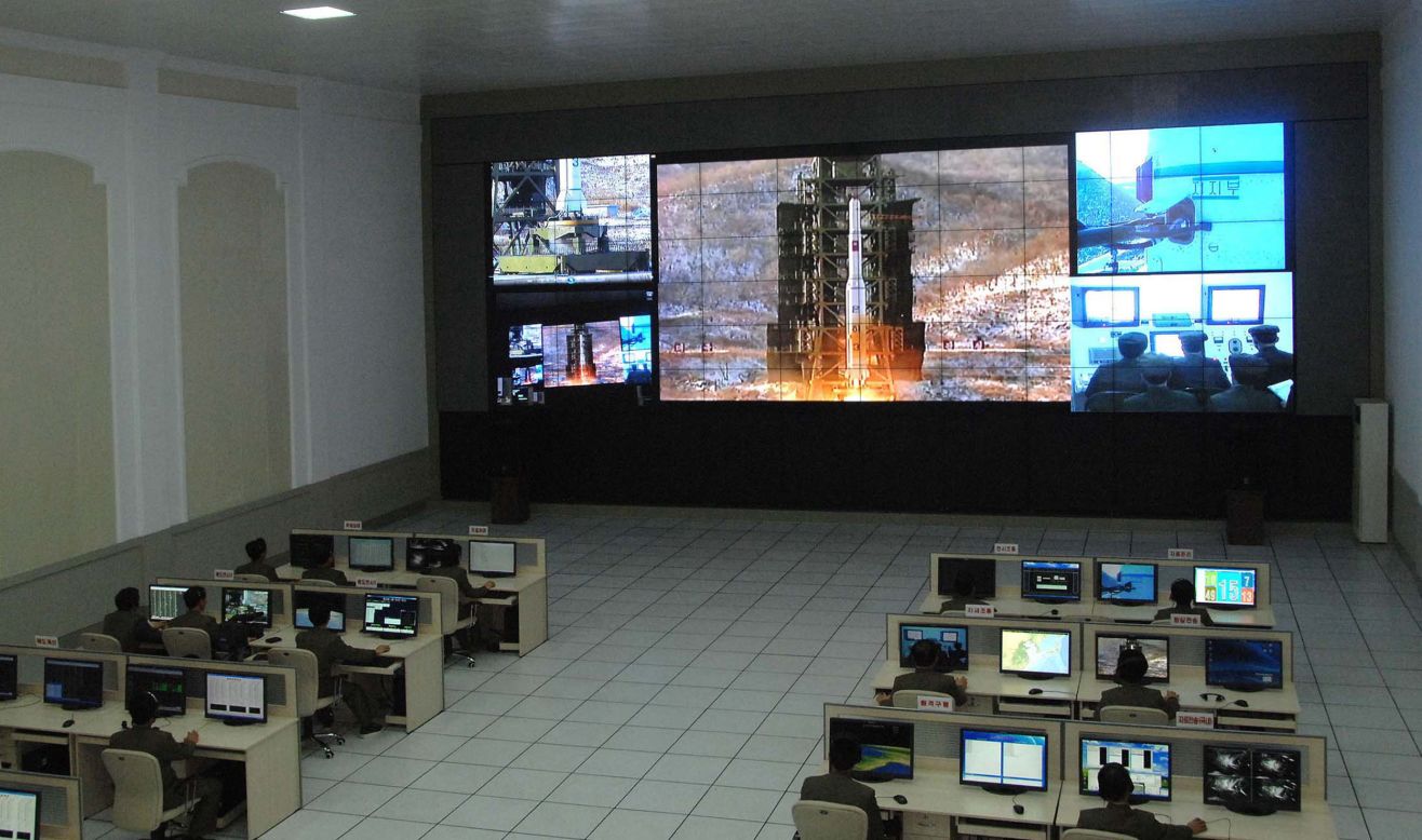Technicians monitor the launch at the control center. The event allowed North Korea to flex its military and technological muscle on the world stage.