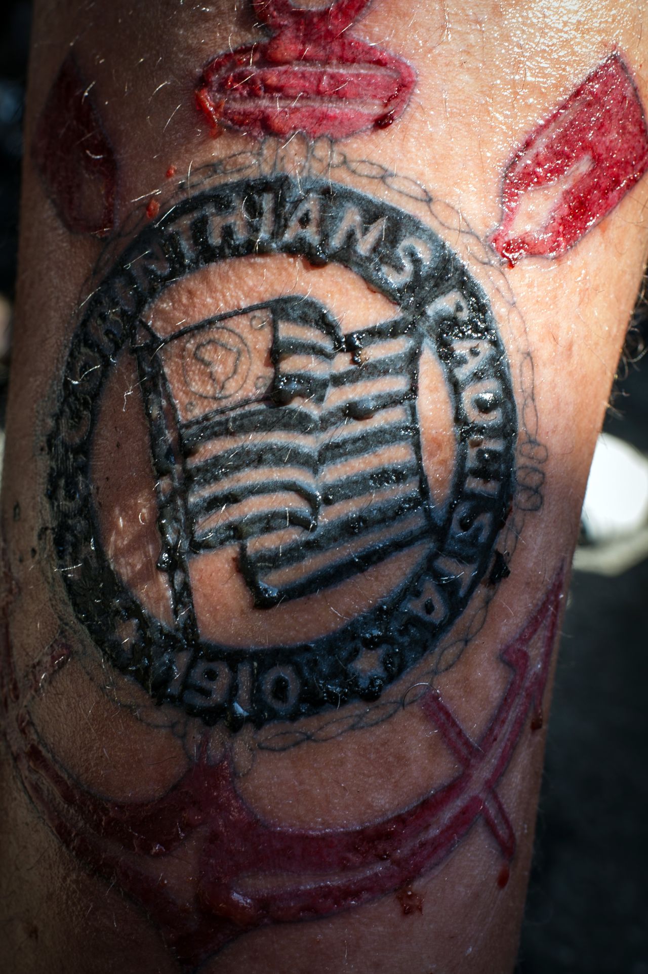 A Corinthians fans shows off his tattoo with the emblem of the team in Sao Paulo.