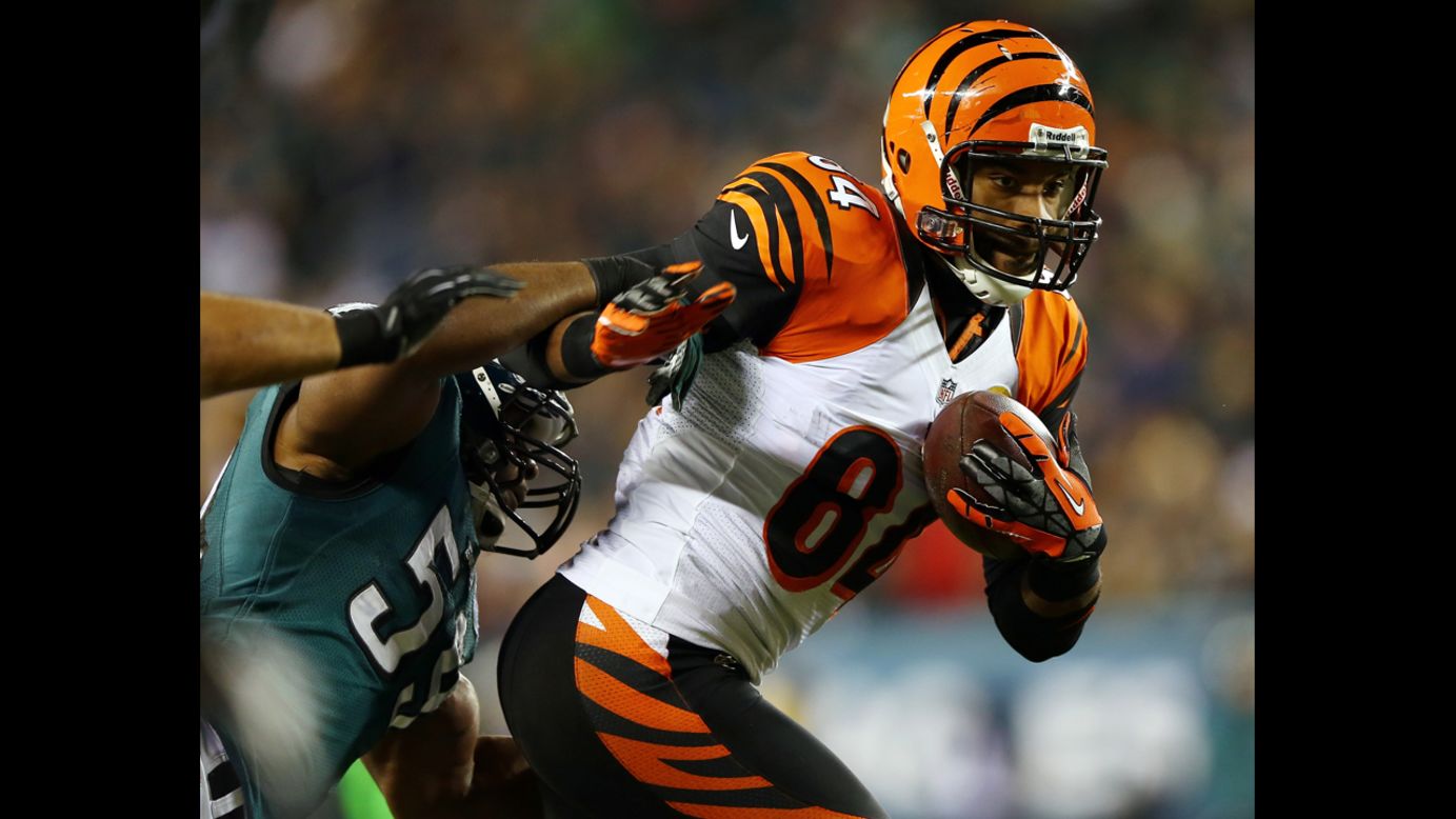 Jermaine Gresham of the Cincinnati Bengals carries the ball as DeMeco Ryans of the Philadelphia Eagles tries to tackle him on December 13.