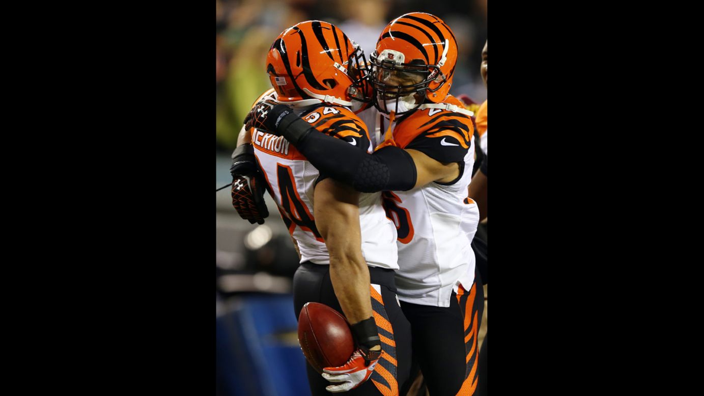 Dan Herron of the Cincinnati Bengals is congratulated by teammate Taylor Mays after Herron recovered a fumble from his blocked punt in the first quarter against the Philadelphia Eagles on December 13.