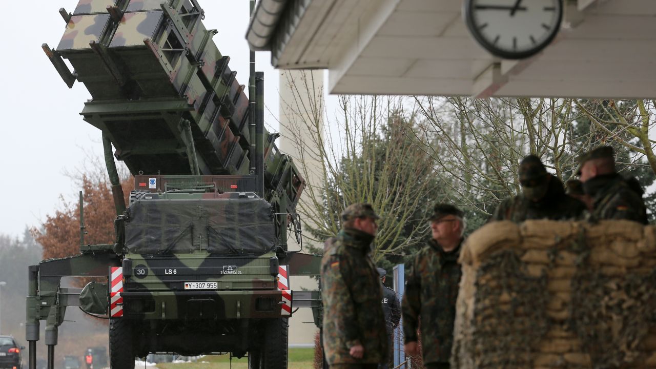 Soldiers of the Air Defence Missile Squadron 2 stand guard with Patriot missile launchers in the background in Bad Suelze, northern Germany on December 4, 2012.