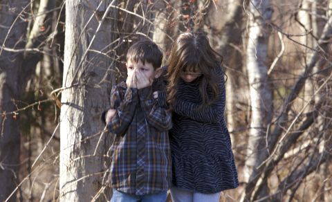 Children wait outside Sandy Hook Elementary School in Newtown, Connecticut, after the shooting.