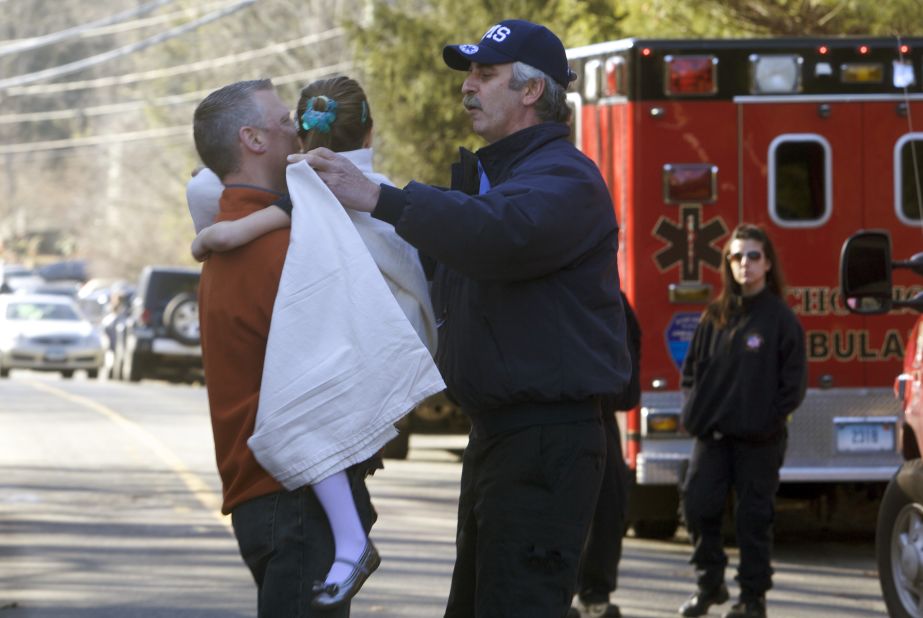 A young girl is given a blanket after being evacuated from Sandy Hook Elementary School on December 14.