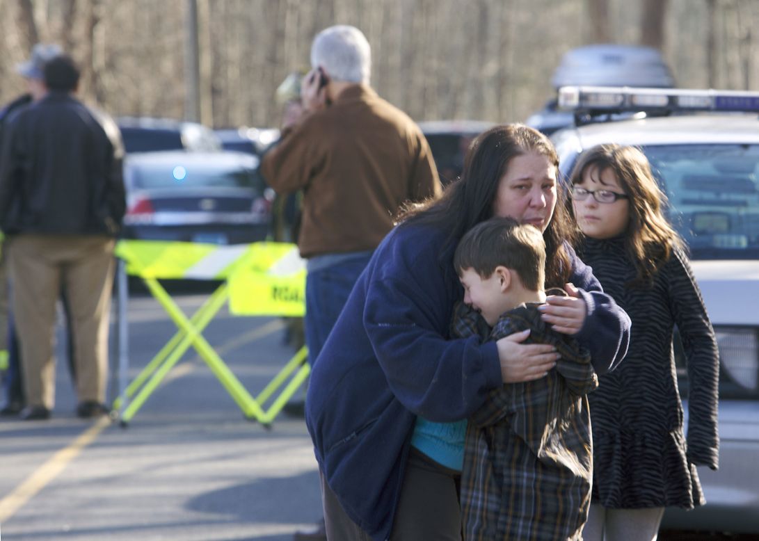 A young boy is comforted outside Sandy Hook Elementary School on December 14.