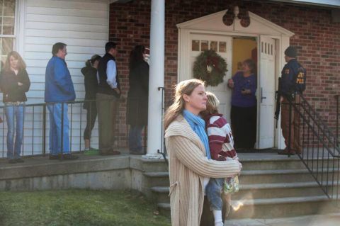 People line up to enter Newtown Methodist Church near the the scene of the shooting on December 14.