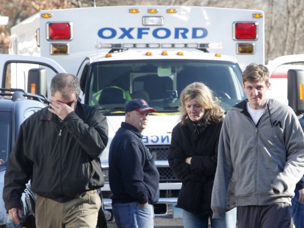 People take in the news outside Sandy Hook Elementary School on December 14.