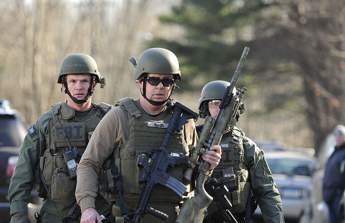 FBI SWAT team members walk along Dickinson Drive near Sandy Hook Elementary School on December 14.