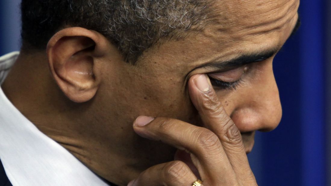 President Barack Obama wipes a tear as he speaks about the shooting at Sandy Hook Elementary School during a press briefing at the White House on December 14.