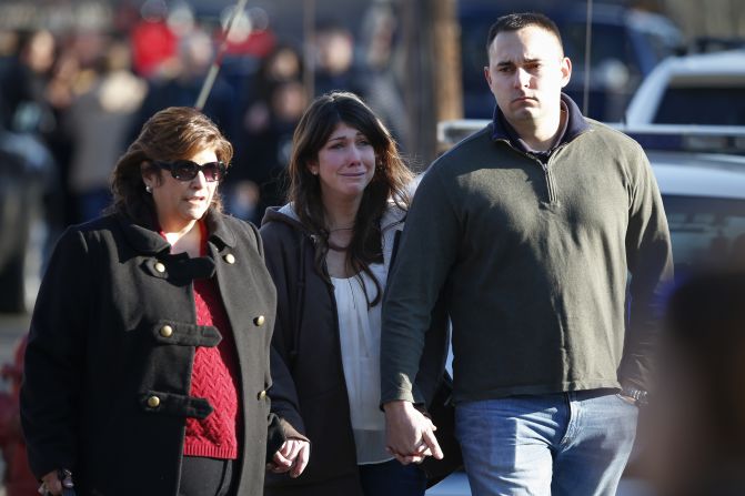 A woman weeps near the site of a shooting at Sandy Hook Elementary School on December 14.