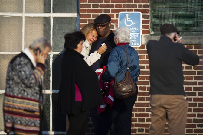 A woman leans on a man as she weeps near Sandy Hook Elementary School on December 14.