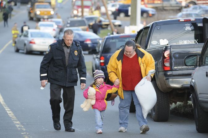 A child and her mother leave a staging area outside Sandy Hook Elementary School in Newtown, Connecticut, on December 14. 