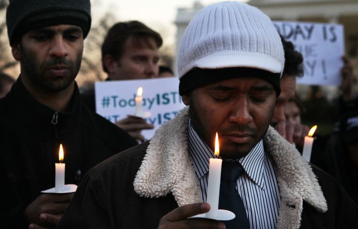 Faisal Ali, right, of Colorado Springs, Colorado, joins the vigil outside the White House.