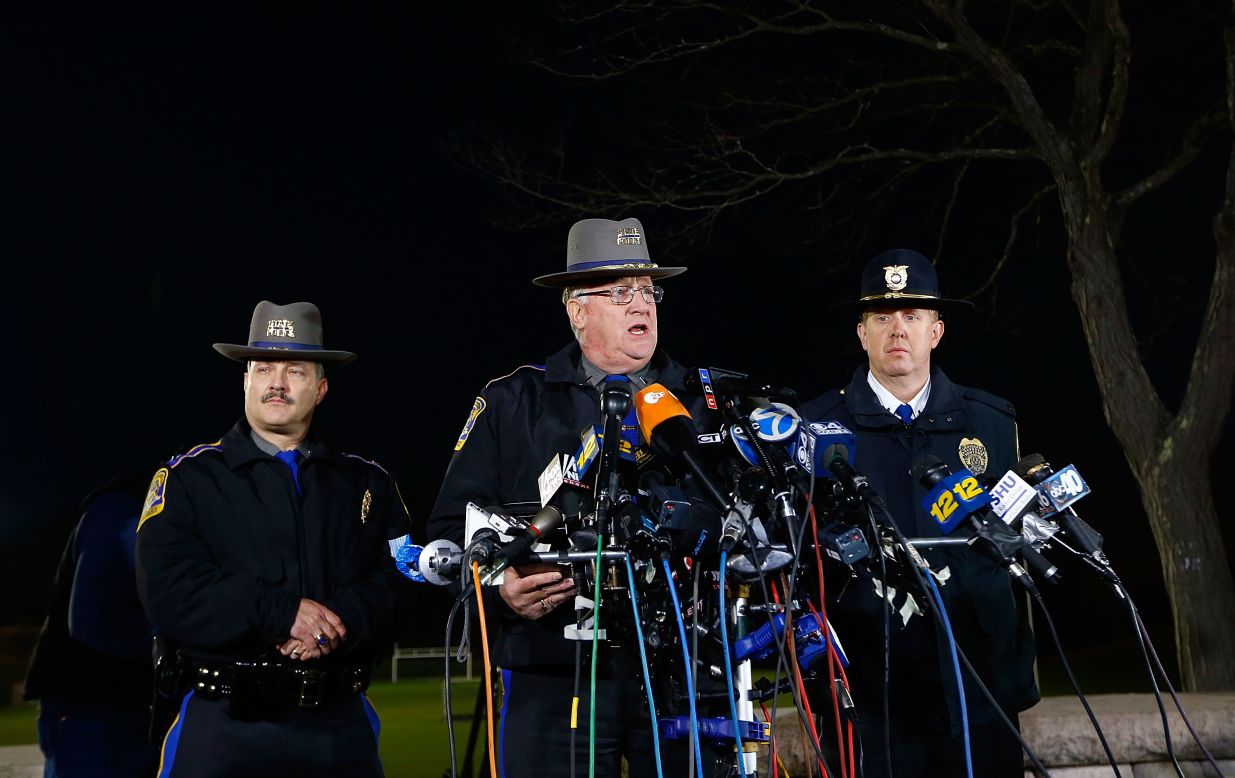 Connecticut State Police spokesman Lt. J. Paul Vance, center, briefs the media on the elementary school shootings during a press conference at Treadwell Memorial Park on December 14 in Newtown.