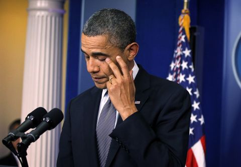 Obama wipes tears as he makes a statement in response to the shooting on Friday.
