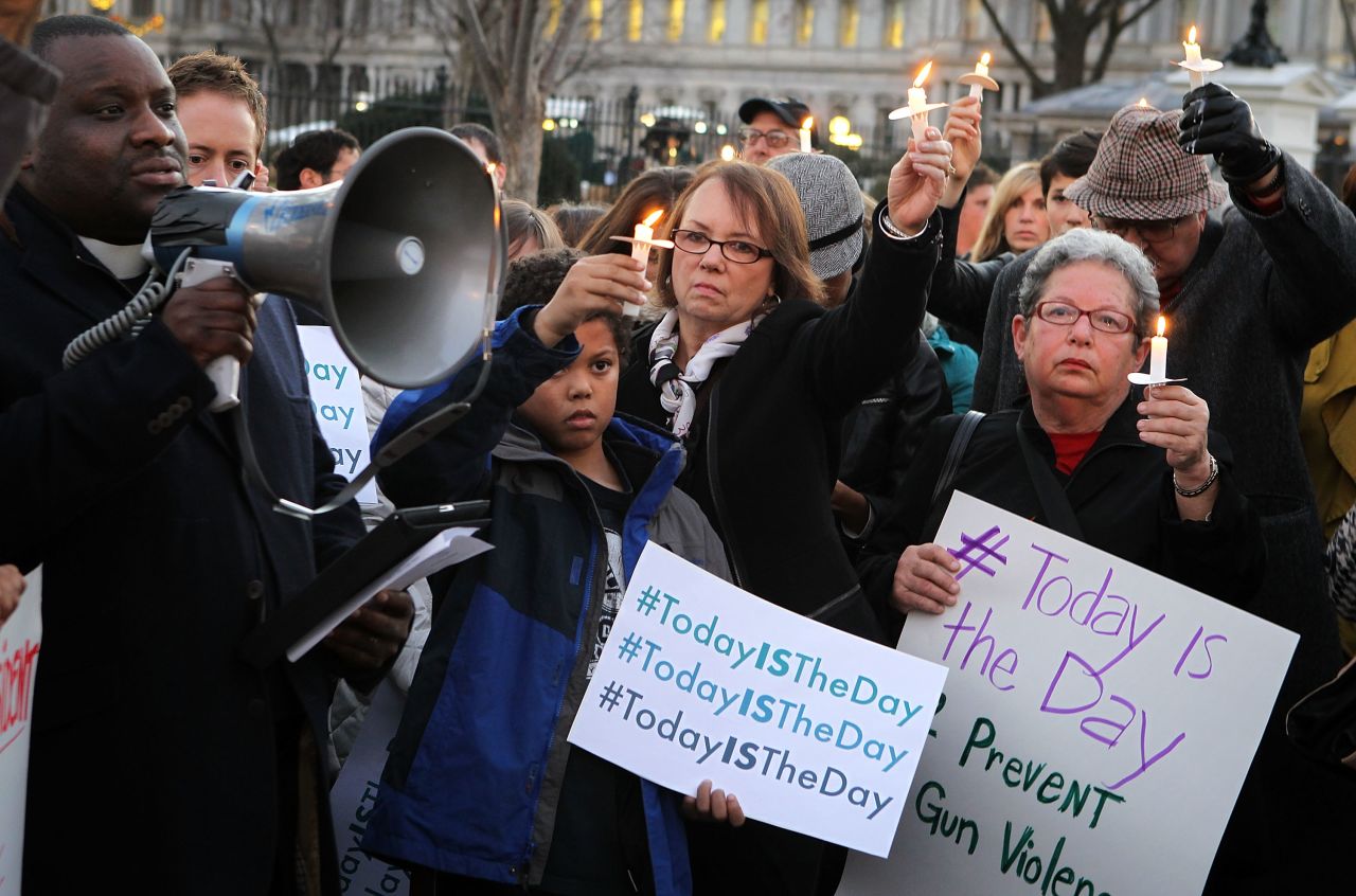People gather outside the White House to participate in a candlelight vigil.
