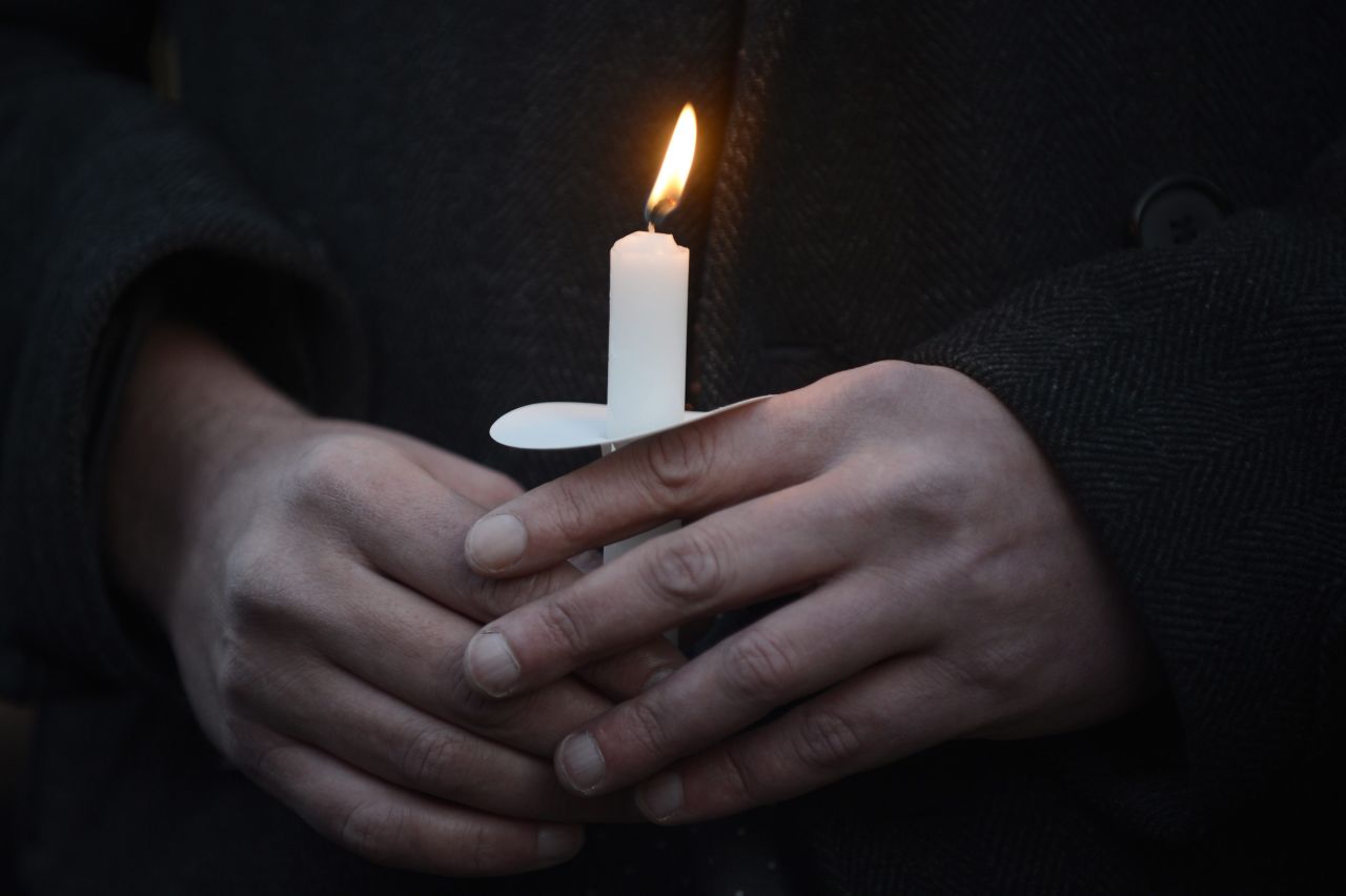 Supporters of gun control hold a candlelight vigil for victims of the shooting outside the White House.