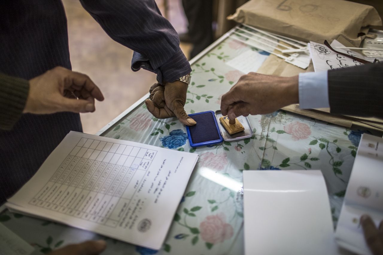A man dips his finger on an ink pad to mark his vote in the referendum on December 15, 2012 in Cairo, Egypt.