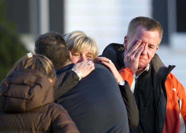 Distraught people leave the fire station after hearing news of their loved ones from officials on Friday.