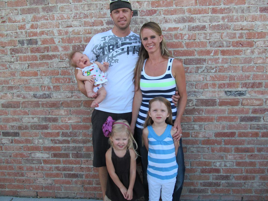 Kayce Johnson, a survivor of the Columbine massacre, is pictured with her husband Patrick and their three daughters