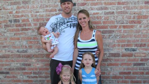 Kayce Johnson, a survivor of the Columbine massacre, is pictured with her husband Patrick and their three daughters