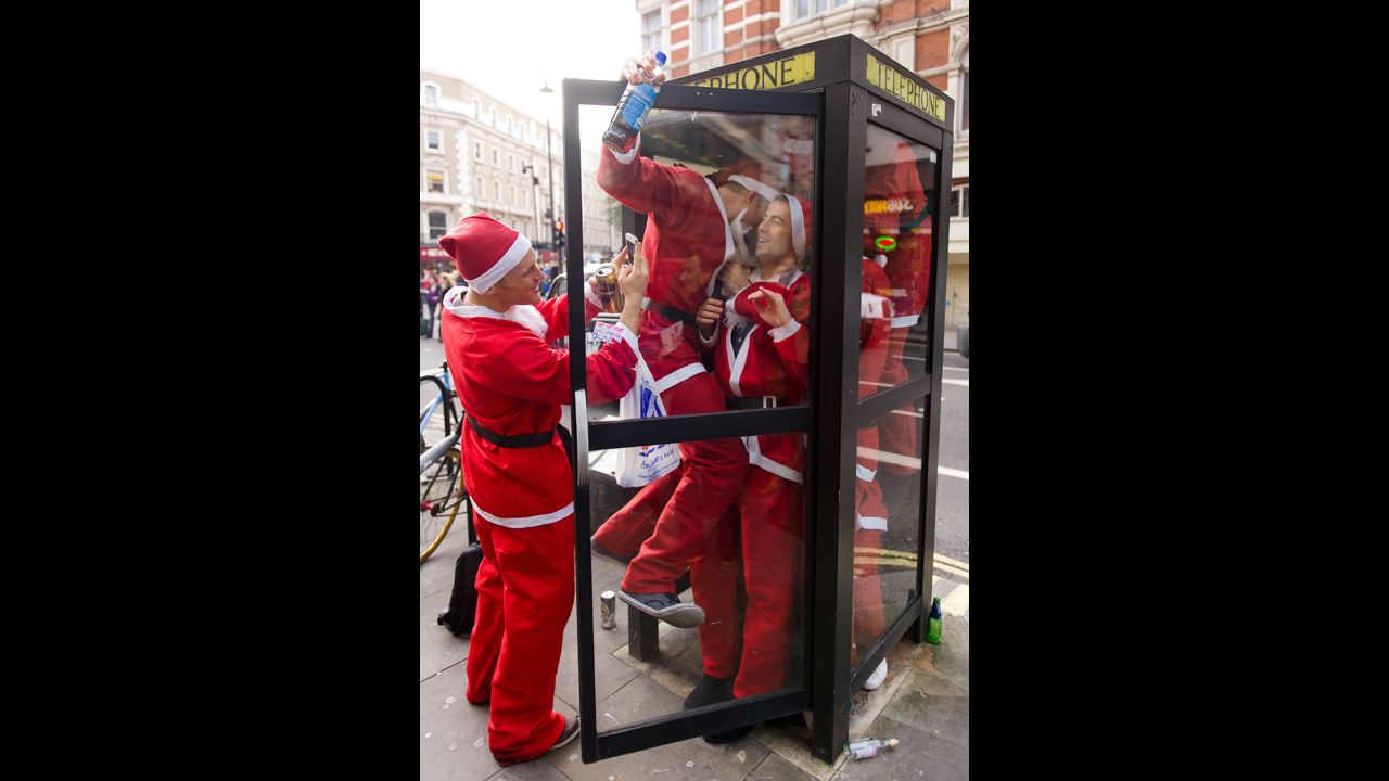 Costumed Santas crowd into a telephone booth during the Santacon pub crawl near London's Trafalgar Square on December 15.