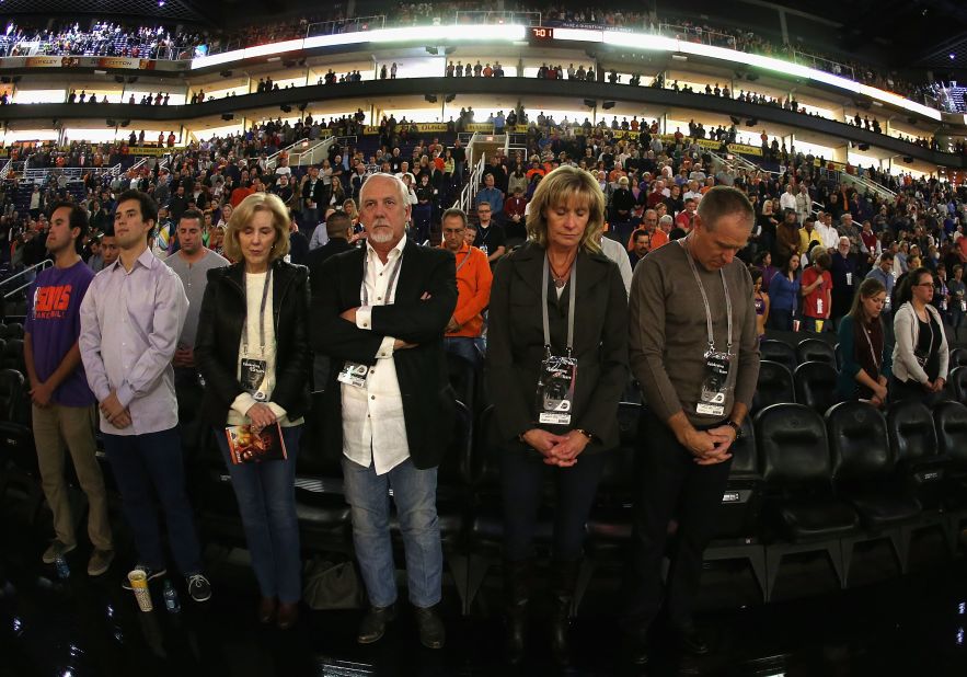 Fans at the NBA game between the Utah Jazz and the Phoenix Suns participate in a moment of silence for the victims of the Newtown shooting on Friday in Phoenix.