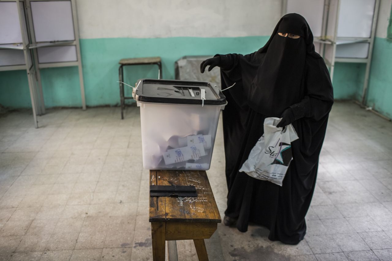 An Egyptian woman casts her vote during a referendum on the new Egyptian constitution on December 15, 2012 in Cairo, Egypt.