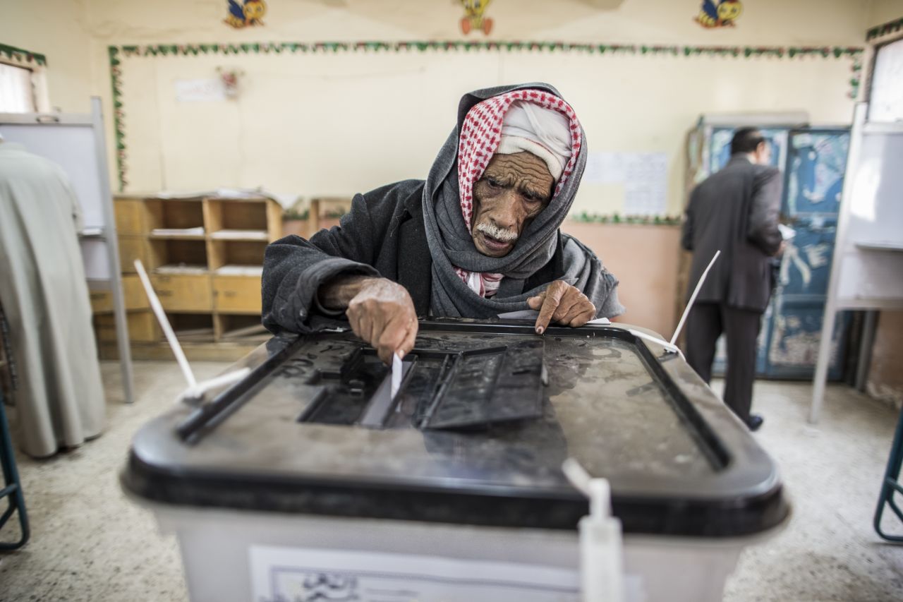 An Egyptian man casts his vote during a referendum on the new Egyptian constitution at a polling station on December 15, 2012 in Cairo, Egypt.