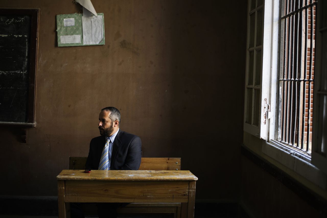 An Egyptian electoral official oversees voting activities as people cast their vote at a polling station in President Mohamed Morsi's hometown Zagazig in the Nile Delta on December 15, 2012.