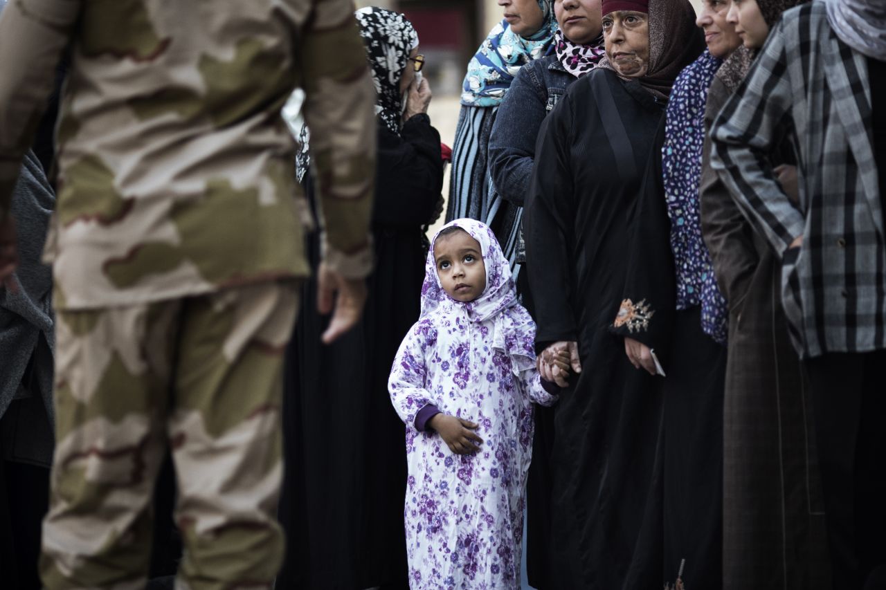An Egyptian girl waits with relatives queuing to vote at a polling station in central Cairo n December 15, 2012.