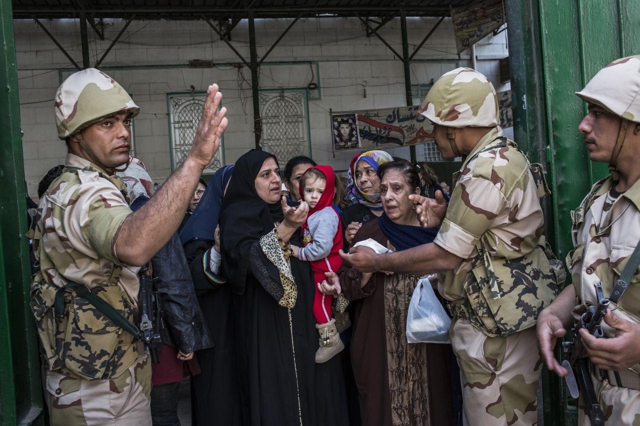 Soldiers check the identity of voters as Egyptian women line-up to cast their vote on December 15, 2012 in Cairo, Egypt.