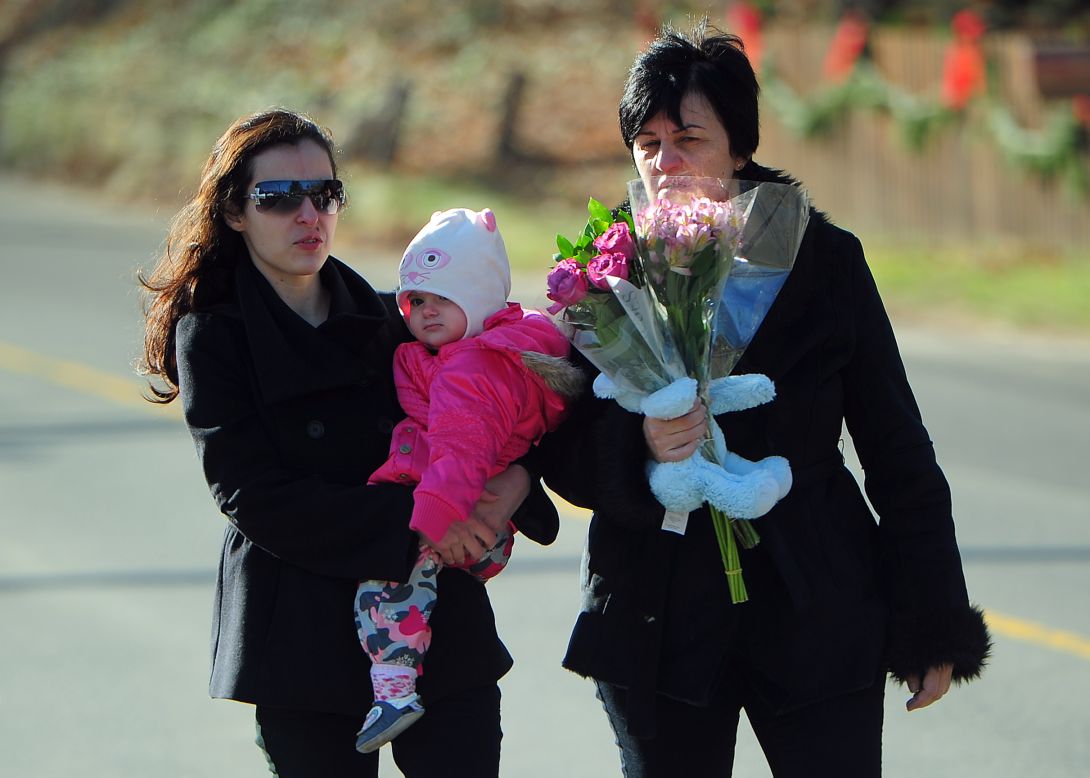 Residents arrive Saturday to pay tribute to the victims of an elementary school shooting in Newtown, Connecticut.