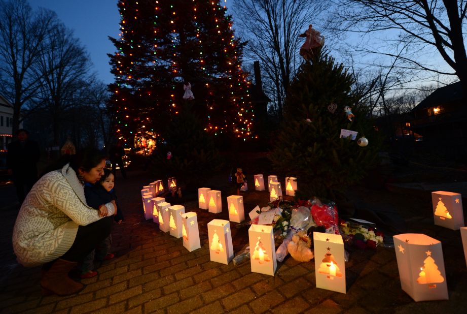 Candles burn next to a lighted tree at a makeshift shrine in Newtown, Connecticut, commemorating the victims of the mass shooting at Sandy Hook Elementary School on December 14, 2012.