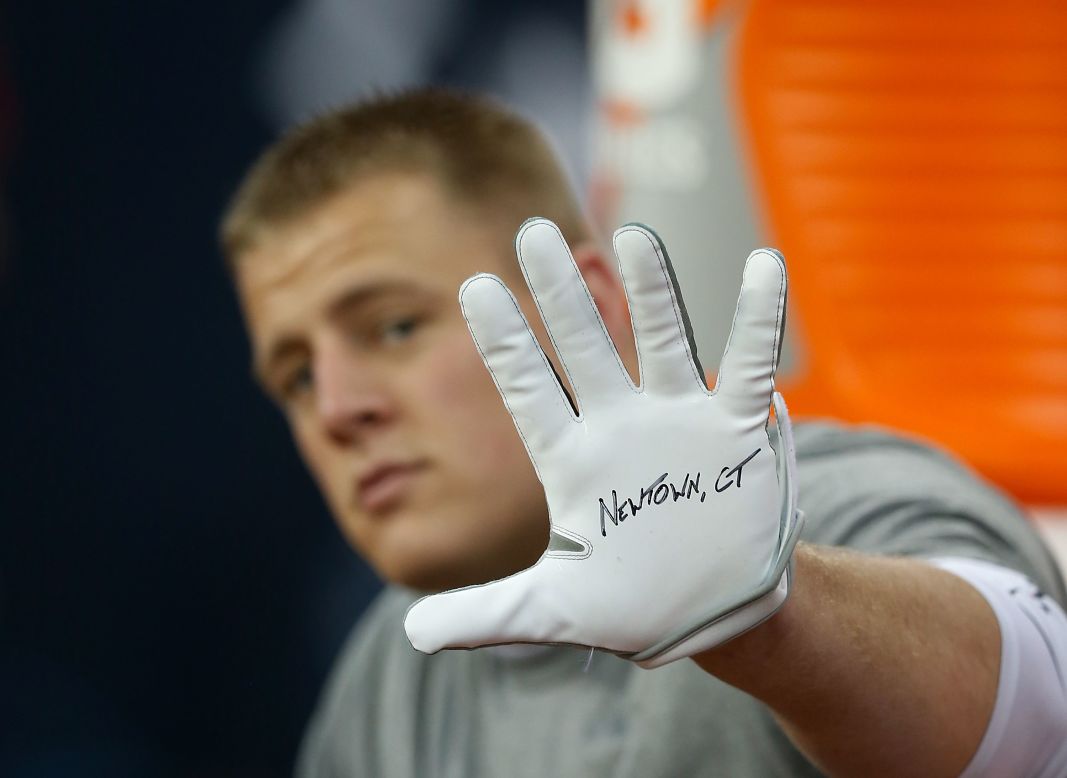 J.J. Watt of the Houston Texans shows his glove in remembrance of the victims before the start of a game against the Indianapolis Colts on December 16 in Houston. 