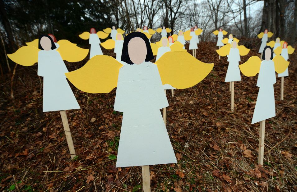 Angel wood cutouts for each of the 27 victims are set up on hillside in Newtown on December 16.