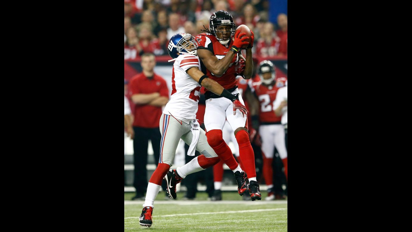 Roddy White of the Falcons pulls in this reception against Jayron Hosley of the Giants on Sunday.