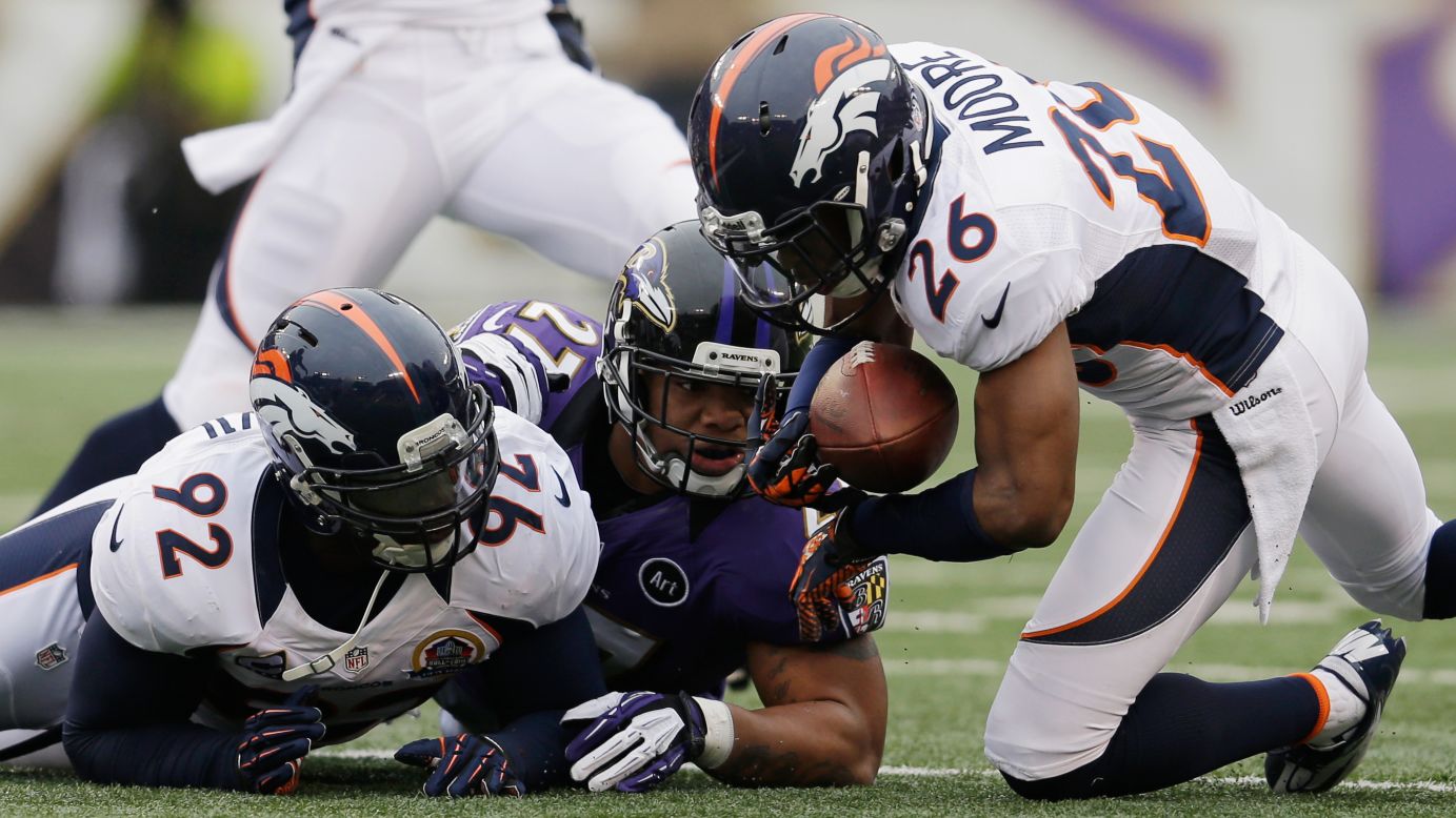 Free safety Rahim Moore of the Broncos recovers a fumble in front of running back Ray Rice of the Ravens and teammate Elvis Dumervil during the first half on Sunday.