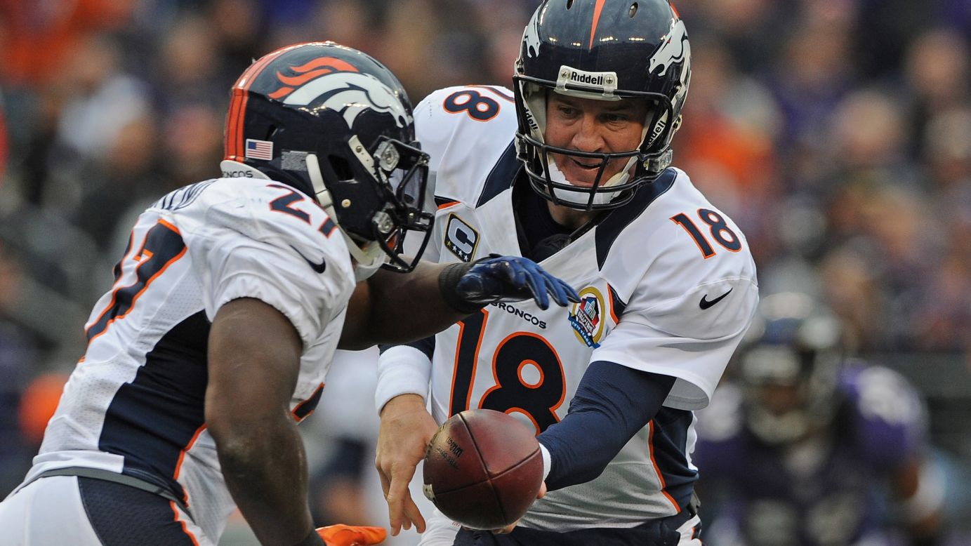Quarterback Peyton Manning of the Broncos hands off to teammate Knowshon Moreno against the Ravens in the first quarter on Sunday.